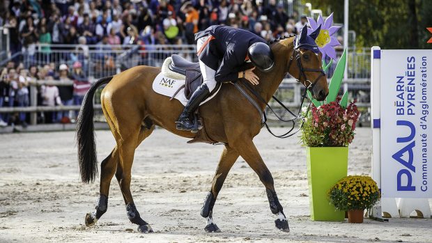 Tom McEwen leans down to kiss Toledo De Kerser on the neck after winning Pau five-star in 2019.