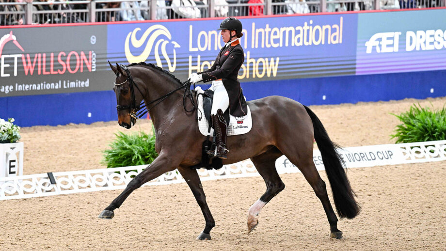 Becky Moody riding Jagerbomb in trot across the diagonal at the London International Horse Show 2024