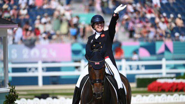 Becky Moody waves to the crowds after a dressage test at the Paris 2024 Olympic Games.