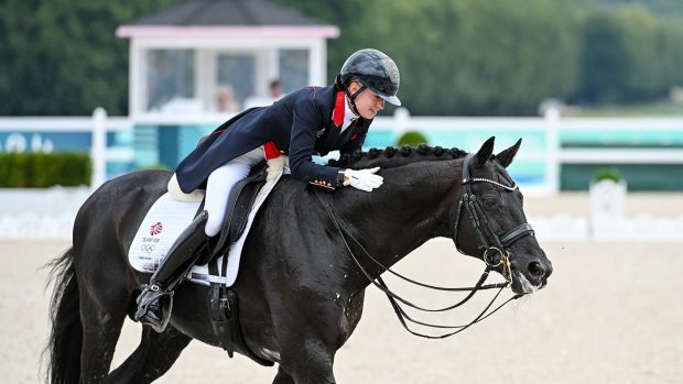 Lottie Fry thanks Glamourdale with a stroke on the neck after his grand prix special performance