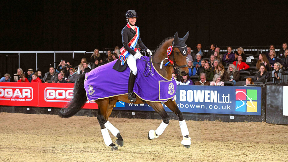 Laura Tomlinson smiles at the camera while on her victory lap on Forest Hill after winning the Dressage Future Elite Championship at HOYS 2024.